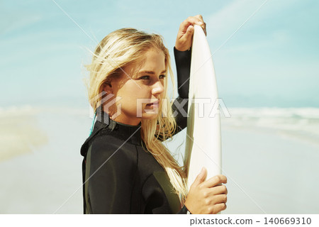 Surfer, face and surfboard for surfing in beach, Cape Town and training for sports in nature. Athlete, outdoor and adventure in sea, free and swimsuit for waves in summer, water and natural in sun 140669310