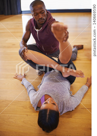 Dancer, coach and stretching with help for legs in class for warm up, fitness or muscle on floor. Man, woman and support for dancing, workout or ready to start with creativity in studio for exercise Dancer, coach and stretching with help for legs in class for warm up, fitness or muscle on floor. Man, woman and support for dancing, workout or ready to start with creativity in studio for exercise 140669590