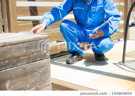 Workers inspecting wooden decks and partitions. 140669604