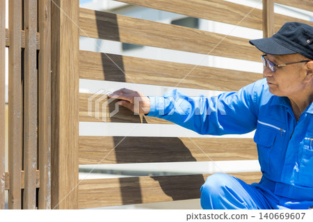 Workers inspecting wooden decks and partitions. 140669607
