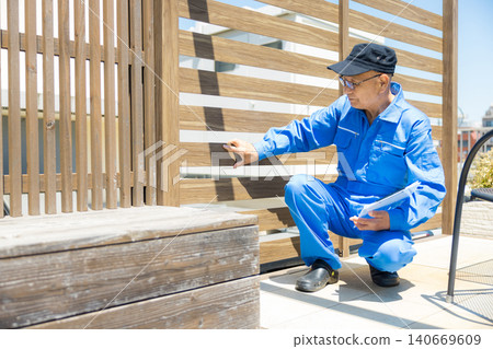Workers inspecting wooden decks and partitions. 140669609