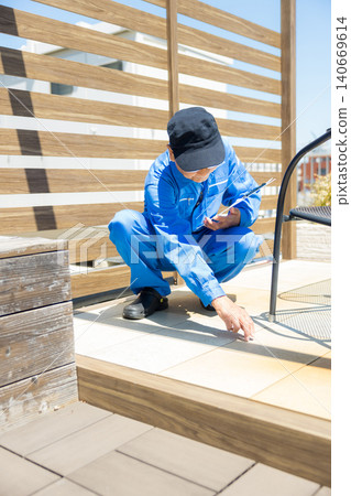 Workers inspecting wooden decks and partitions. 140669614