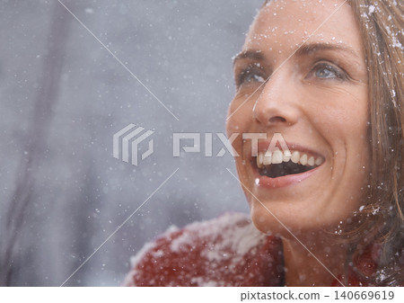 Happy, excited and face of woman with snow outdoors for season, snowing weather and cold climate. Travel, fashion and person smile in nature on winter holiday, vacation and weekend in Switzerland 140669619