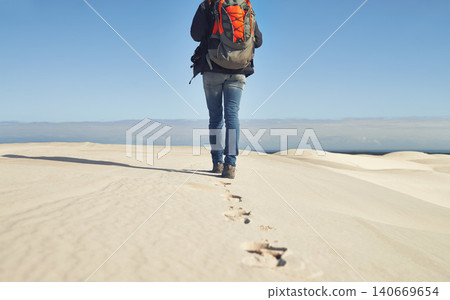 Walking, sand dunes or legs of person for adventure, desert landscape and travel for holiday vacation trip. Back view, hiker and nomad explorer hiking in Sahara terrain, outdoor and dry climate Walking, sand dunes or legs of person for adventure, desert landscape and travel for holiday vacation trip. Back view, hiker and nomad explorer hiking in Sahara terrain, outdoor and dry climate 140669654