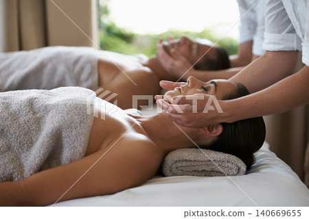 Hands, face massage and couple in spa to relax on bed for luxury pamper treatment together in hotel. Beauty, facial or zen woman with man at resort or salon for natural healing benefits or skincare Hands, face massage and couple in spa to relax on bed for luxury pamper treatment together in hotel. Beauty, facial or zen woman with man at resort or salon for natural healing benefits or skincare 140669655