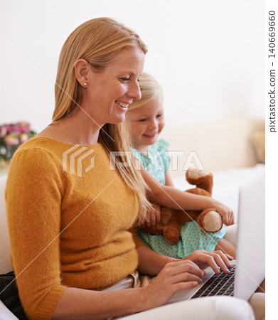 Happy mother, child and relax with laptop on sofa for online entertainment, social media or networking at home. Mom, kid or daughter with smile on technology for streaming or subscription at house 140669660