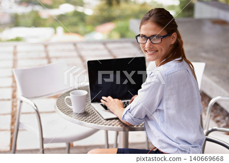Businesswoman, portrait and laptop typing at cafe, restaurant or coffee shop for communication, internet and technology. Female person, professional or entrepreneur with computer for startup business 140669668