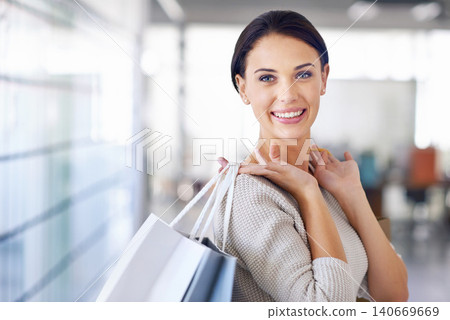 Portrait, smile and woman with shopping bags for sales, fashion or discount at retail store for commerce. Face, customer and happy person with gifts at mall or boutique for purchase of casual clothes 140669669