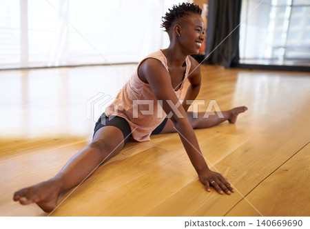 Dancer, stretching and person on floor in studio or academy preparing for practice and start rehearsal in exercise. Training, fitness and healthy workout for legs with yoga, pilates and happiness 140669690