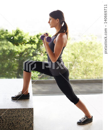 Balcony, woman and exercise with dumbbell to workout for healthy living or fitness, committed and focus in Los Angeles. Female person, house and weights for training with wellbeing and self care Balcony, woman and exercise with dumbbell to workout for healthy living or fitness, committed and focus in Los Angeles. Female person, house and weights for training with wellbeing and self care 140669711