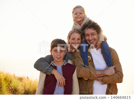 Family, portrait and smile with field, walk and sunrise for morning exercise and bond. Parents, children and countryside for health, wellness and outdoor adventure at sunset for holiday or vacation. Family, portrait and smile with field, walk and sunrise for morning exercise and bond. Parents, children and countryside for health, wellness and outdoor adventure at sunset for holiday or vacation. 140669815