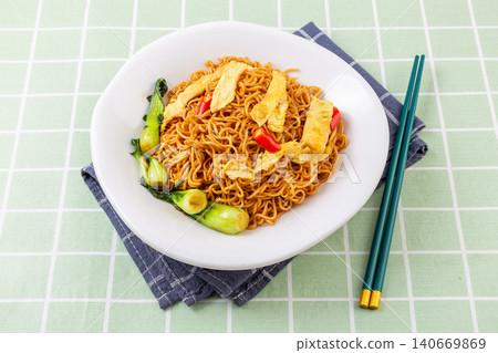 classic Chinese Stir-Fried Noodles with Eggs and Vegetables, Chow Mein in Ceramic Bowl 140669869