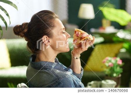 Woman Enjoying a Moment of Domestic Comfort with Pizza Woman Enjoying a Moment of Domestic Comfort with Pizza 140670098