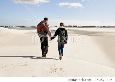 Backpack, travel or couple in desert holding hands for adventure, journey or resort, location or explore. Freedom, love or back of people in Egypt for sand dunes walking, wellness or hiking in nature Backpack, travel or couple in desert holding hands for adventure, journey or resort, location or explore. Freedom, love or back of people in Egypt for sand dunes walking, wellness or hiking in nature 140670246