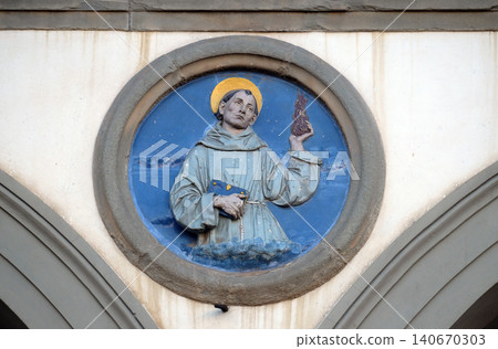 St. Anthony of Padua, glazed terracotta tondo by Andrea della Robbia, located between two arches of the old Ospedale di San Paolo, in Florence, Italy St. Anthony of Padua, glazed terracotta tondo by Andrea della Robbia, located between two arches of the old Ospedale di San Paolo, in Florence, Italy 140670303