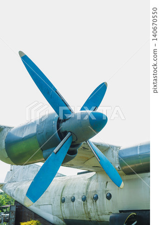 Close view of a vintage aircraft propeller at a museum in the afternoon light showing details of blue blades against a clear sky Close view of a vintage aircraft propeller at a museum in the afternoon light showing details of blue blades against a clear sky 140670550