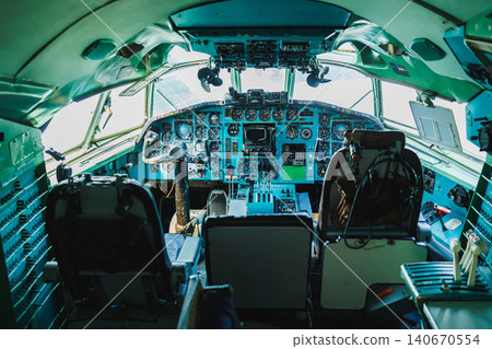 Historic aircraft cockpit with controls and instruments visible during daylight hours at an aviation museum Historic aircraft cockpit with controls and instruments visible during daylight hours at an aviation museum 140670554