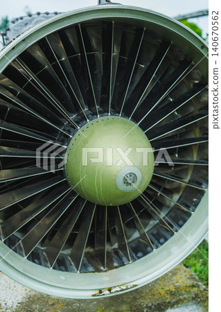 Close view of a jet engine during maintenance at an aircraft hangar showing detailed parts and inner components Close view of a jet engine during maintenance at an aircraft hangar showing detailed parts and inner components 140670562