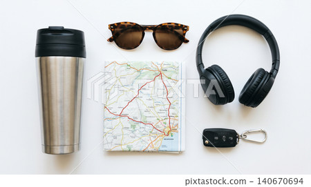 Travel essentials flat lay with thermos map sunglasses headphones car keys essentials navigation sunglasses headphones vacation planning adventure technology accessories lifestyle equipment Travel essentials flat lay with thermos map sunglasses headphones car keys essentials navigation sunglasses headphones vacation planning adventure technology accessories lifestyle equipment 140670694