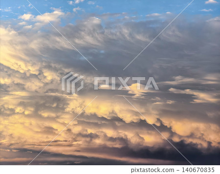Layered Mammatus Clouds Glowing In Sunset Sky Layered Mammatus Clouds Glowing In Sunset Sky 140670835