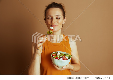 Woman Enjoying a Mindful Moment with Salad Woman Enjoying a Mindful Moment with Salad 140670873