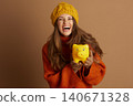 Cheerful Woman Celebrating Financial Savings 140671328