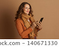 Middle-Aged Woman Engaging with Smartphone Display 140671330