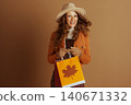 Cheerful Woman with Fedora and Autumn Shopping 140671332