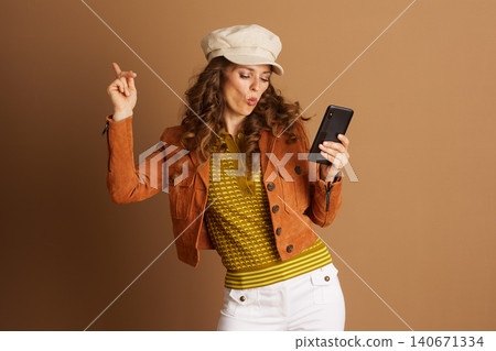 Engaged Woman with Smartphone and Pursed Lips Engaged Woman with Smartphone and Pursed Lips 140671334