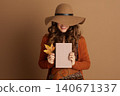 Cozy Autumn Reading, Woman in Rust Cardigan 140671337