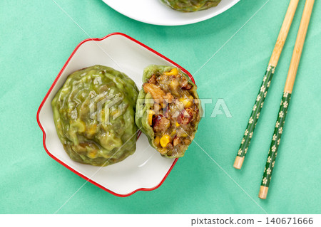 sliced steamed sticky grain bun stacked on a small white plate with chopsticks background sliced steamed sticky grain bun stacked on a small white plate with chopsticks background 140671666