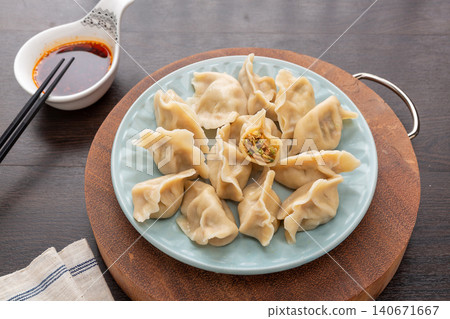 chinese Dumplings with Pagoda Tree Flowers and Lean Pork Filling, Traditional Homemade Jiaozi chinese Dumplings with Pagoda Tree Flowers and Lean Pork Filling, Traditional Homemade Jiaozi 140671667