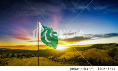 The national flag of Pakistan waving on a hilltop against a dramatic sunset and starry sky The national flag of Pakistan waving on a hilltop against a dramatic sunset and starry sky 140671753