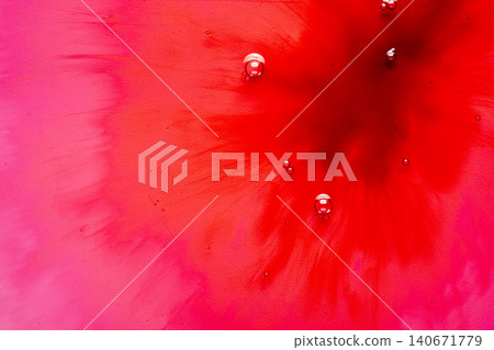 Macro view of red and pink liquid ink diffusing with small bubbles 140671779
