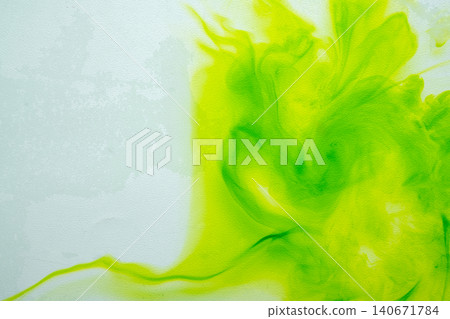 A vibrant abstract background featuring bright green and lime yellow ink or watercolor paint diffusing and swirling smoothly on a light textured canvas surface A vibrant abstract background featuring bright green and lime yellow ink or watercolor paint diffusing and swirling smoothly on a light textured canvas surface 140671784
