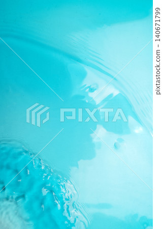 Clear turquoise blue water surface with gentle ripples and sunlight reflections. Perfect abstract background for summer or wellness themes Clear turquoise blue water surface with gentle ripples and sunlight reflections. Perfect abstract background for summer or wellness themes 140671799