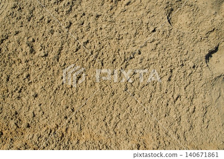 Golden quarry sand layer close-up with uneven granular compression, highlighting heavy texture Golden quarry sand layer close-up with uneven granular compression, highlighting heavy texture 140671861