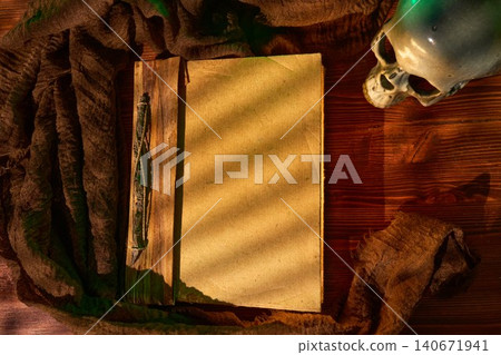 Ancient volume with skull lighting. Eerie still life composition featuring vintage book and skull under green illumination Ancient volume with skull lighting. Eerie still life composition featuring vintage book and skull under green illumination 140671941