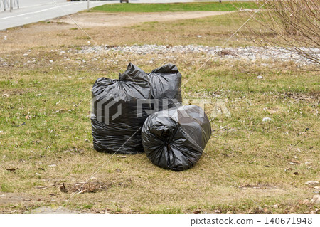 Cleaning the city: bags of fallen leaves and litter on the ground Cleaning the city: bags of fallen leaves and litter on the ground 140671948