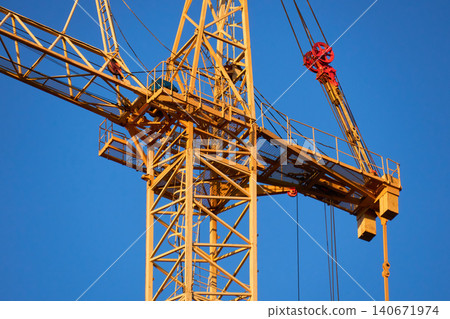 Abstract industrial composition of an orange crane jib and sky Abstract industrial composition of an orange crane jib and sky 140671974