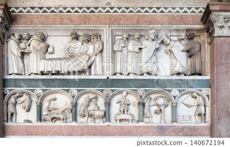 Detail of the bass-relief representing the Stories of St. Martin and the Labor of the months of the year; preserved in the Portico of the Cathedral of St. Martin in Lucca, Italy Detail of the bass-relief representing the Stories of St. Martin and the Labor of the months of the year; preserved in the Portico of the Cathedral of St. Martin in Lucca, Italy 140672194