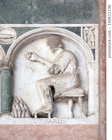 January, detail of the bass-relief representing the Labor of the months of the year, portal of the Cathedral of St Martin in Lucca, Italy January, detail of the bass-relief representing the Labor of the months of the year, portal of the Cathedral of St Martin in Lucca, Italy 140672196
