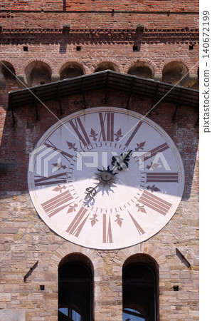 Torre dell'Orologio, Stone Bell Tower (Campanile) topped with brick arch and clock with roman numerals in Lucca, Italy Torre dell'Orologio, Stone Bell Tower (Campanile) topped with brick arch and clock with roman numerals in Lucca, Italy 140672199