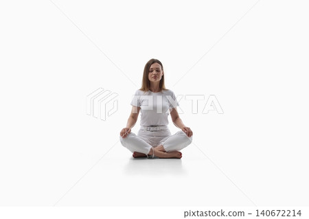 Calm young woman meditating in lotus pose on white background. Calm young woman meditating in lotus pose on white background. 140672214