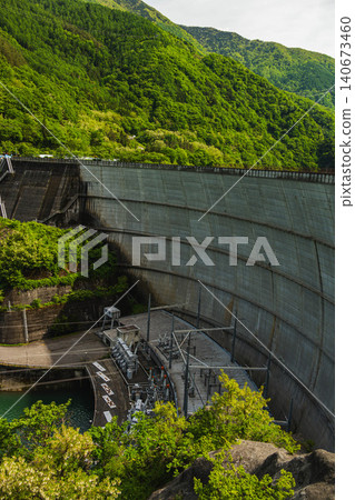 The beautiful arch-type concrete dam "Mizudono Dam" surrounded by fresh greenery. The beautiful arch-type concrete dam "Mizudono Dam" surrounded by fresh greenery. 140673460