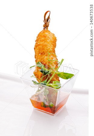Fried shrimp skewer in plastic cup with sauce Fried shrimp skewer in plastic cup with sauce 140673538