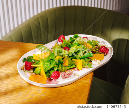 Fresh fruit salad with greens and raspberry Fresh fruit salad with greens and raspberry 140673543