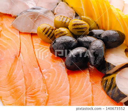 Fresh fish platter with salmon, mackerel, and olives 140673552