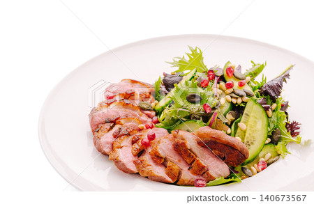 Duck breast slices with fresh green salad and pomegranate Duck breast slices with fresh green salad and pomegranate 140673567