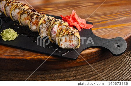 Warm fried sushi rolls on slate board with ginger and wasabi Warm fried sushi rolls on slate board with ginger and wasabi 140673586